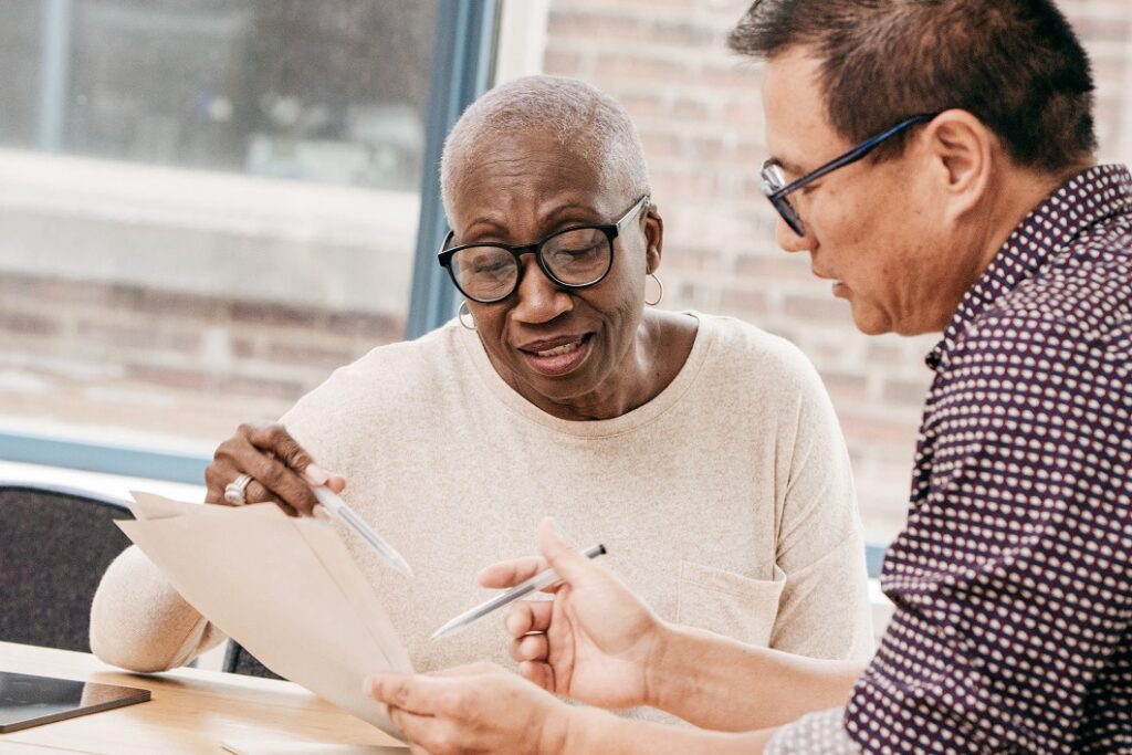 Medical assistant helping patient to understand information