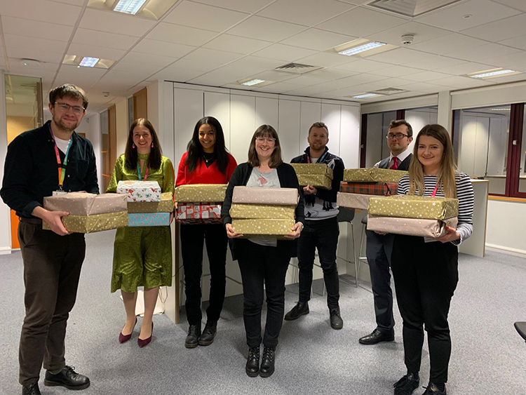 Team holding presents