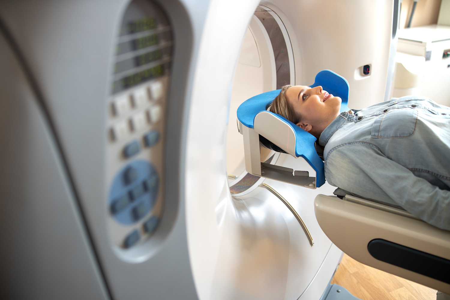 Patient lying on CT machine table at radiology clinic