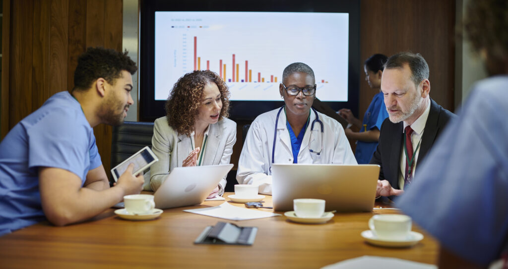 Medical team sat around table and in discussion