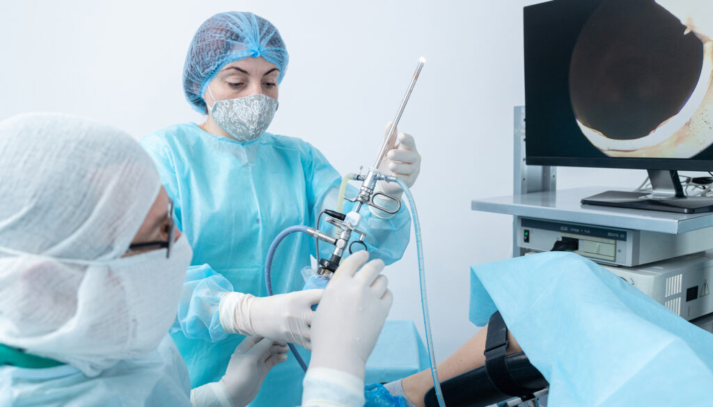 Medical team using equipment in clinical room