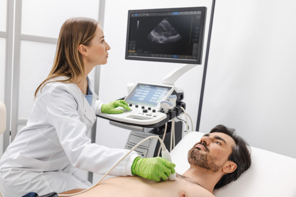 Heart ultrasound examination on patient by cardiologist.