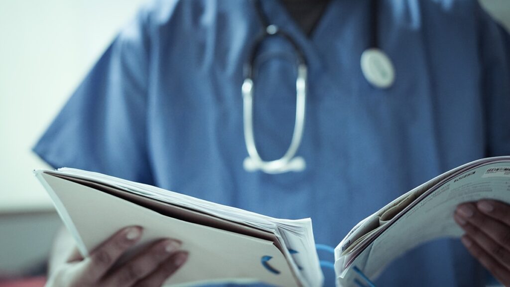 Hospital medical staff reads patient notes
